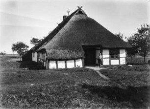 Fachwerkhaus : Ein Fachwerkhaus mit Reetdach im Fischerdorf Mzezyno (Treptower Deep). Vor dem Eingang steht ein Mädchen.