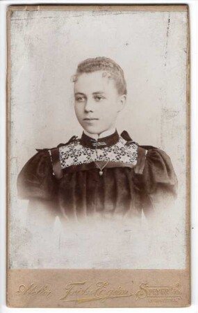 Portrait einer jungen Dame mit krausem Haar.