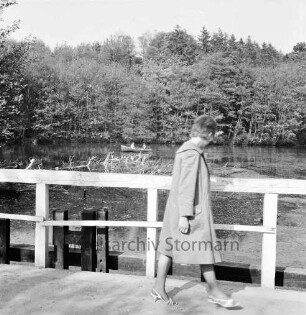 Kupfermühle: Kupfermühlenteich: Brücke und Bootsanleger: vorn Spaziergängerin an Geländer: hinten Ruderboot mit zwei Personen: dahinter Wald