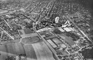 Dresden. Plauen und Südvorstadt von Südosten mit Sportflugzeug Klemm L-25 der SA-Fliegerstrum-Staffel (Reklameflug für Sturm-Zigarettenfabrik Arthur Dreßler Dresden)