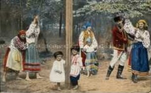 Mann, Frauen und Kinder in ukrainischer Volkstracht beim Tanz