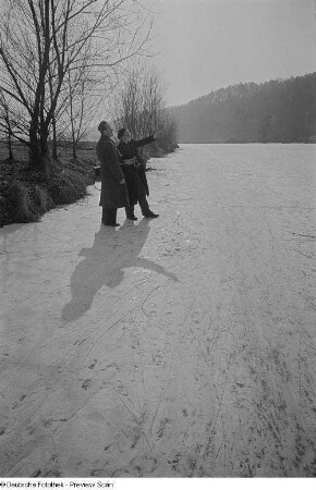 Roger Rössing und ein weiterer Mann mit Fotoapparat (Reiner?) unterhalten sich in einer Schneelandschaft