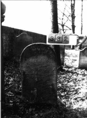Grabstein 332 (Index: 100115813) Material: Sandstein Zustand: stark verwittert mit fast völligem Textverlust Maße HxBxT: 81x44x10 cm Beschreibung: Stele mit Rundbogenabschluß Symbolik: Ranken: Grabstein 332