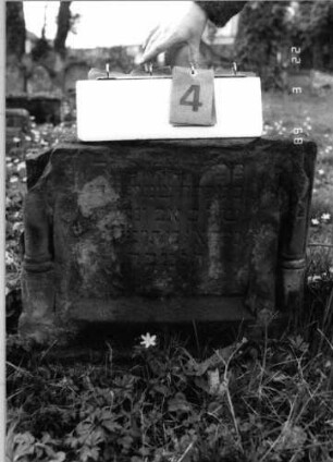 Grabstein 4 (Index: 99791855) Material: Sandstein Zustand: stark verwittert mit Textverlust, nur noch untere Hälfte der Stele vorhanden Maße HxBxT: 47x55x24 cm Beschreibung: ädikulaartige Stele mit Halbsäulen: Grabstein 4