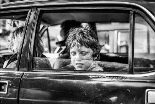 London, Straßenszene mit Jungen im Auto. Sommersprossen