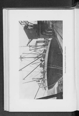 Hamburg freighter at a pier, discharging.