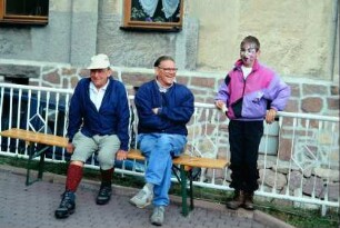 Umwelttag: Wanderer auf einer Bank; bemalter Junge