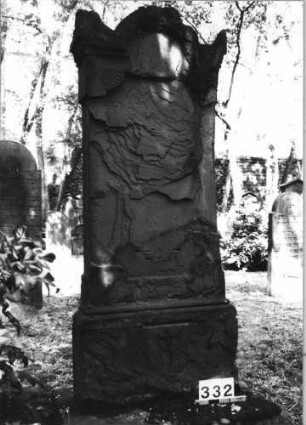 Grabstein 332 (Index: 99629835) Material: Sandstein Zustand: völlig abgeblättert/großer Textverlust Maße HxBxT: 175x71x19 cm Beschreibung: Stele auf Sockel mit eingezogenem Rundbogenabschluß mit Eckakroteren Symbolik: Eckakroterien, Halbblüten an Ecken des Schriftfeldes: Grabstein 332