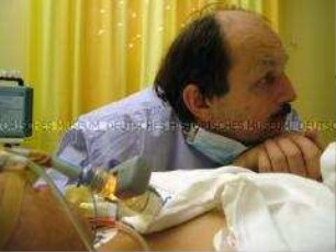 Mann am Krankenbett der Schwester (Prämiertes Foto D)