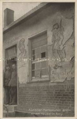 Karikaturen an einem Haus in der französischen Stadt Amy
