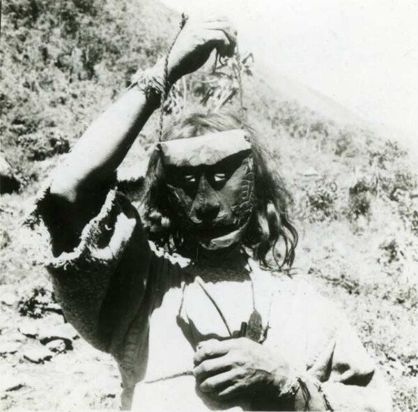 Temple servant from the large dance hut shows me his wooden masks.