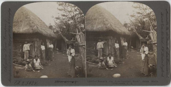 Group of people in front of a hut.