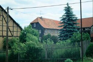 Blick auf ein großes Bauernhaus mit Scheune