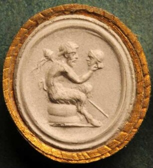 Ein sitzender Satyr hält eine Maske in der Hand (Daktyliothek, Supplement)