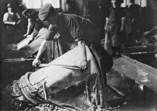 Freiberg-Zug, An der Zugspitze 42. Lederfabrik Zug. Werkteil Zugspitze. Gerberei. Arbeiter beim Entfleischen mit traditionellen Werkzeugen (Scherdegen und Gerberbaum)