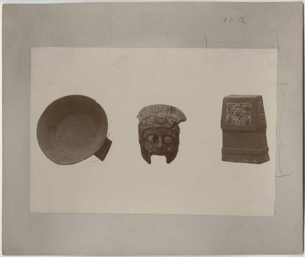 Three clay objects: left: Clay bowl, centre: incomplete clay head, right: small clay replica of a temple sacrarium, with the starry sky frieze