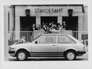 Fotograf mit Hochzeitsgesellschaft vorm Standesamt