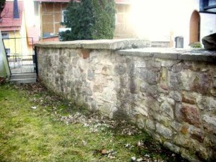 Kirchhofmauer im Südosten (beachte unterschiedlichen Mauersteinverband der einst festen Kirchhofmauer - erhaltene Höhe ein Drittel der Originalen)