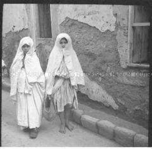 Zwei Kinder in Abayas vor einer Hauswand, Casablanca, Marokko