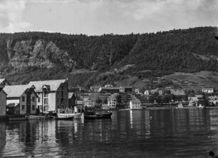 Wohl südliches Norwegen. Ansicht einer Ortschaft mit Hafen