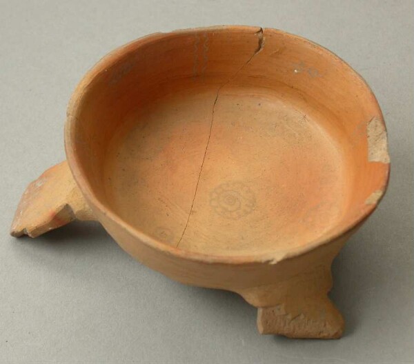 Three-footed clay bowl