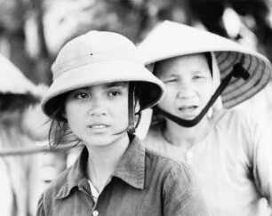 Vietnam. Zwei junge Frauen mit Tropenhelm und Reisstrohhut