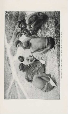 Head-hunters, with their axes, holding a council of war