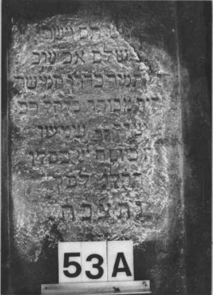 Grabstein 53 (Index: 100105908) Material: Sandstein Zustand: Stein liegend, stark verwittert mit Textverlust Maße HxBxT: 136x54x19 cm Beschreibung: Stele, Sockel, Giebel mit Eckakroteren, rechteckiges Schriftfeld eingetieft: Grabstein 53A