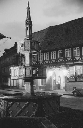 Ansicht des Wohltäterbrunnens in Wernigerode bei Nacht, im Hintergrund das Hotel "Gothisches Haus"