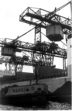 Hamburg. Freihafen. Das schwedische Frachtschiff "Cassiopeia" wird entladen. Es hat Steinkohle nach Hamburg gebracht. Im Vordergrund der Leichter "Hansi"