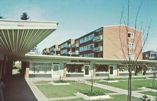 Bahnhofstrasse: Mehrfamilienhäuser, davor Geschäfte