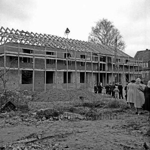 Rathaus: Richtfest: Rohbau mit Gerüst: über Dachstuhl Richtkrone: vorn Baumaterial: hinten rechts Gäste: dahinter Bahnhof Kiekut der Hamburger Hochbahn: hinten Baum