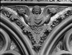 Bogenreliefs: Engel — Ein Engel hält zwei Kronen