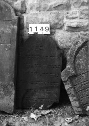 Grabstein 1149 (Index: 99630652) Material: Sandstein Zustand: unten abgebrochen Maße HxBxT: 82x46x4 cm Beschreibung: Stele mit eingezogenem Rundbogenabschluß: Grabstein 1149