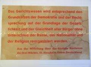 Maueranschlag mit einem Zitat aus der Mitteilung über die Potsdamer Konferenz über die Zukunft Deutschlands