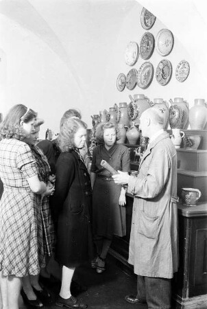 Dresden, Köpckestraße 1: Museum für Sächsische Volkskunst mit Puppentheatersammlung (1927-1949 Oskar-Seyffert-Museum), Ausstellung Erdgeschoßhalle nach Rücktransport der ab 1942 in Schloss Weesenstein eingelagerten Bestände. Mitarbeiter und Besucher (?) vor Nische mit bäuerlicher Keramik