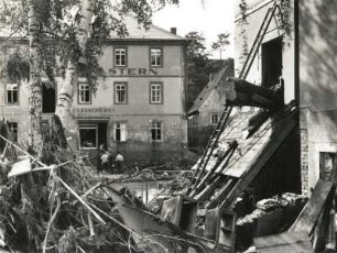 Unwetterkatastrophe im Osterzgebirge am 8./9. Juli 1927. Berggießhübel. Zerstörungen nach der Hochflut. Der Baumstamm rechts gibt die Fluthöhe an und wirkte als Ramme