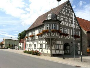 Rathaus (erbaut 1666)-Ansicht querab in Fachwerk-Riegelbauweise (einst offene Erdgeschoßhalle) und Eckerker im Obergeschoß auf Knaggen in Übersicht