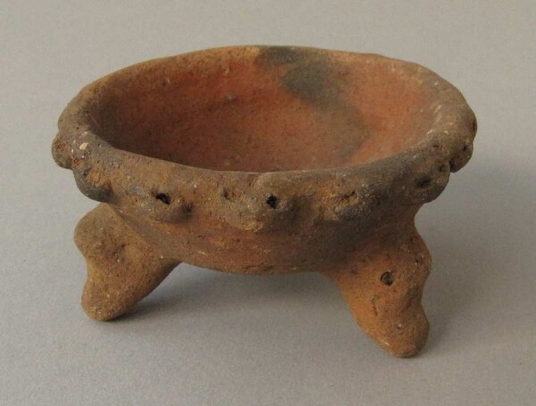 Three-footed clay bowl