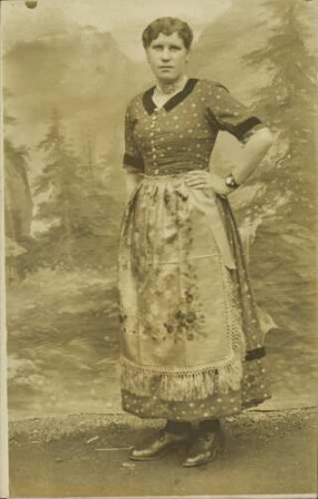 [Porträt einer Frau in gepunktetem Kleid mit Schürze]