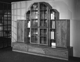 Anbauwand : Dresden-Hellerau. VEB Deutsche Werkstätten Hellerau. Hausmesse, 1986. Anbauwand. Holz, folienbeschichtet in Eichenholzoptik, rustikal (1986; VEB Deutsche Werkstätten Hellerau)