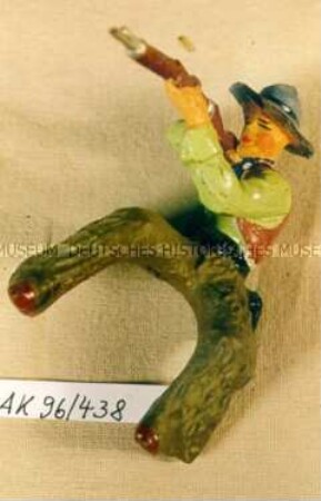 Reitender Cowboy, mit Gewehr zielend