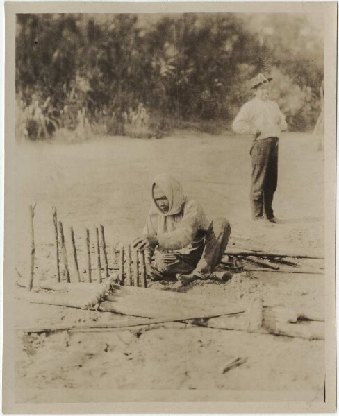 Tumupasa Indian setting up a small trap for mammals