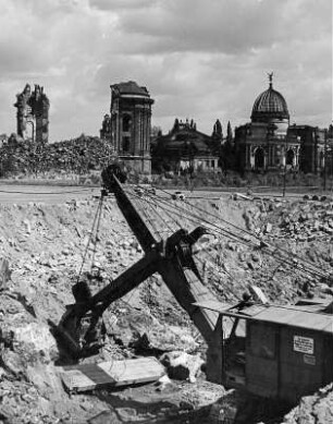 Dresden. Ausheben der Baugrube mit Hochlöffelbagger für die Bebauung der Nordseite Ernst-Thälmann-Straße, Blick gegen Ruine der Frauenkirche und ehem. Kunstakademie