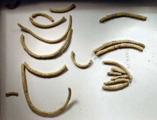 Bleidraht, 17 Stück. Die größten Stücke sind gebogen und scheinen von einer Spirale zu stammen (Armband?)