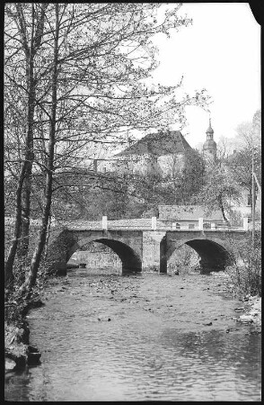 Klingenberg in Sachsen. Wilde Weißeritz mit Brücke. Im Hintergrund das Herrenhaus des Rittergutes mit Turm