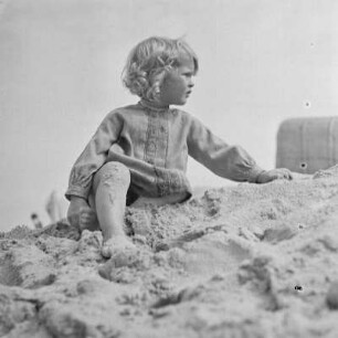 Kleinkind sitzt am Strand