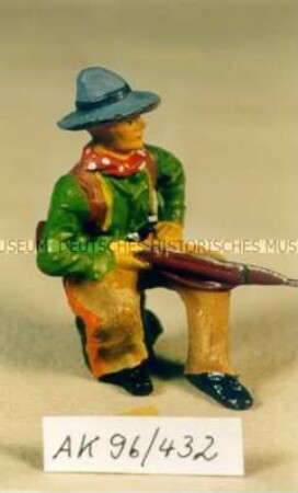 Sitzender Cowboy mit Gewehr