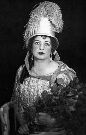 Meta Seinemeyer als Tosca : Meta Seinemeyer als Tosca in der gleichnamigen Oper von Giacomo Puccini. Staatsoper Dresden, Partie ab 6. April 1925 (ab 1. August 1925 Engagement). Hüftbild mit Ehrenschleife und Blumenstrauß. Fotografie (Negativabzug auf Papier) von Ursula Richter