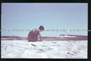 Nackter Soldat am Strand eines Flusses